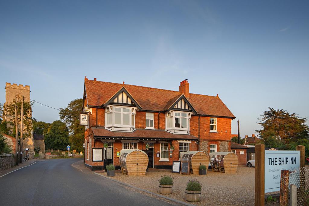 a large brick house on the side of a road at The Ship Inn in Weybourne