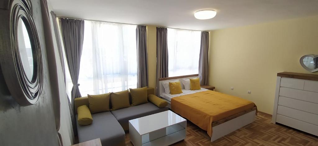 a small bedroom with a couch and a window at Studios near to Burgas Free University in Burgas City