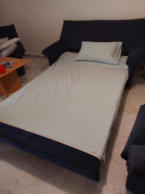 a large bed with a black and white mattress at Luminosa Village Apartment in Iraklitsa