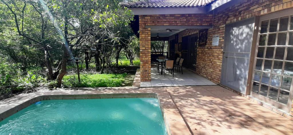 a swimming pool in the backyard of a house at Nature House in Marloth Park