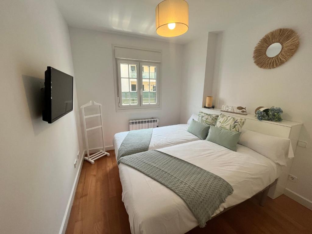 Posteľ alebo postele v izbe v ubytovaní Apartamento con terraza y acceso a la playa