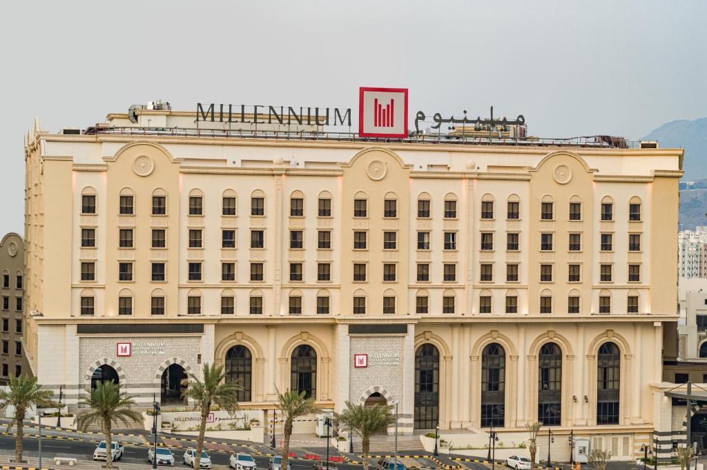 un grand bâtiment avec un panneau en haut dans l'établissement Millennium Makkah Al Naseem, à La Mecque