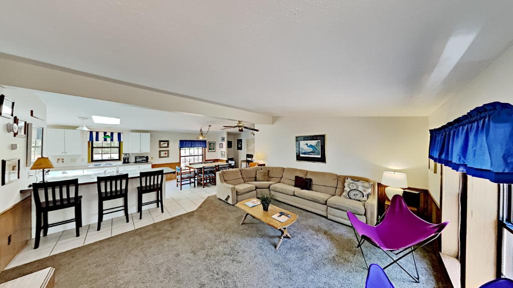 a living room and kitchen with a couch and a table at Put in Bay Island Club 61 in Put-in-Bay