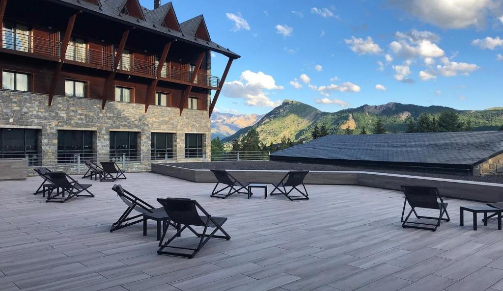 a group of chairs and a table on a patio at HG Alto Aragón in Formigal