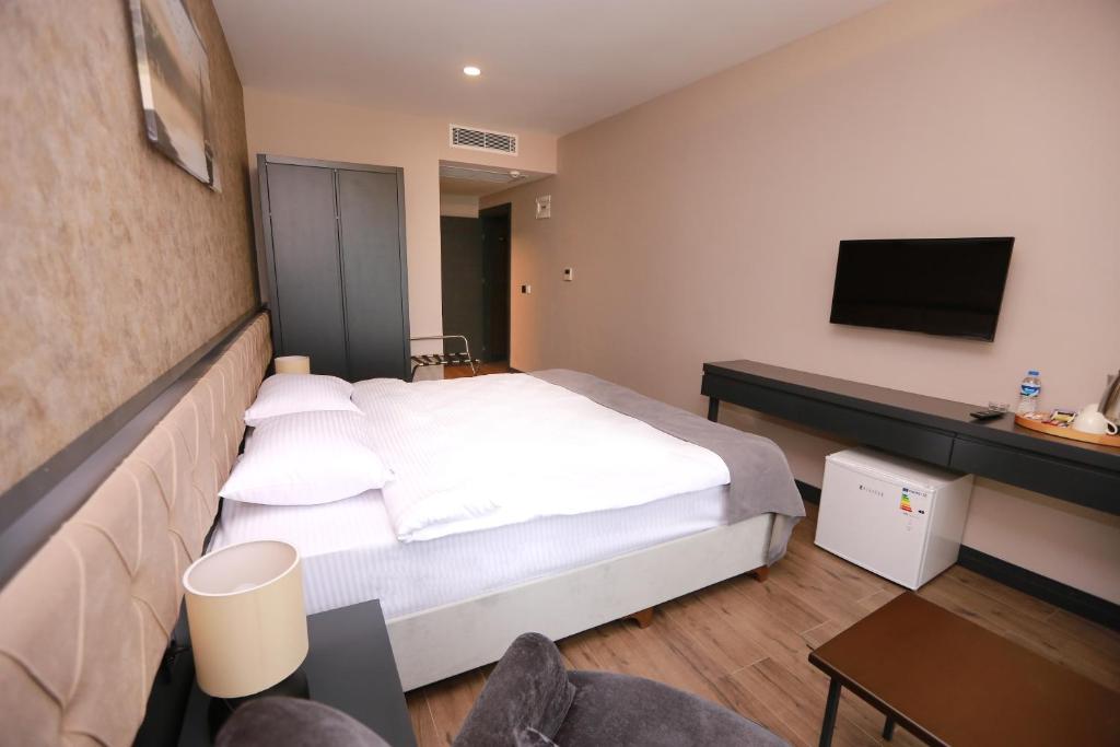 Postel nebo postele na pokoji v ubytování PENTAHOR HOTEL