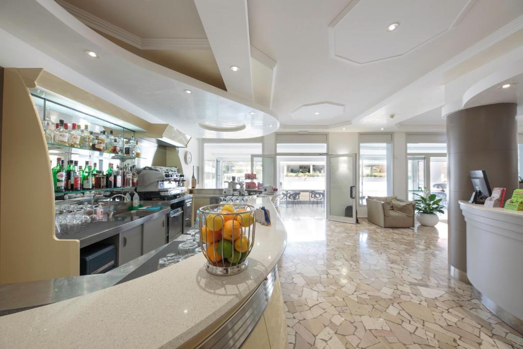 a kitchen with a counter with a vase of fruit at Hotel Bristol in Caorle