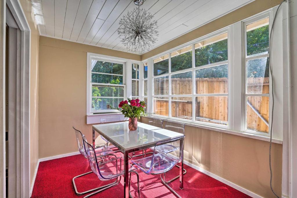 a dining room with a table and chairs and windows at \Sun-Dappled Retreat Walk to Restaurants! in Boulder Creek