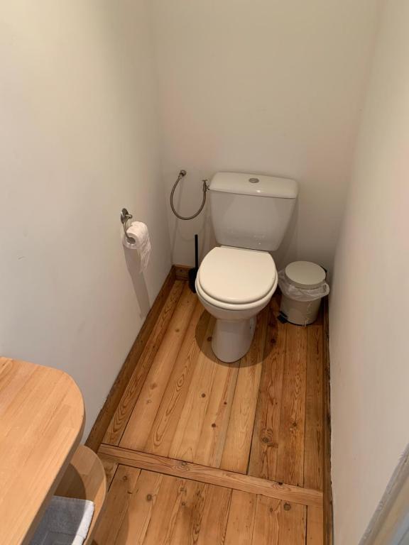 a bathroom with a toilet on a wooden floor at VIEUX LILLE Porte de Gand Bienvenue chez NESTYOU, Lille in Lille