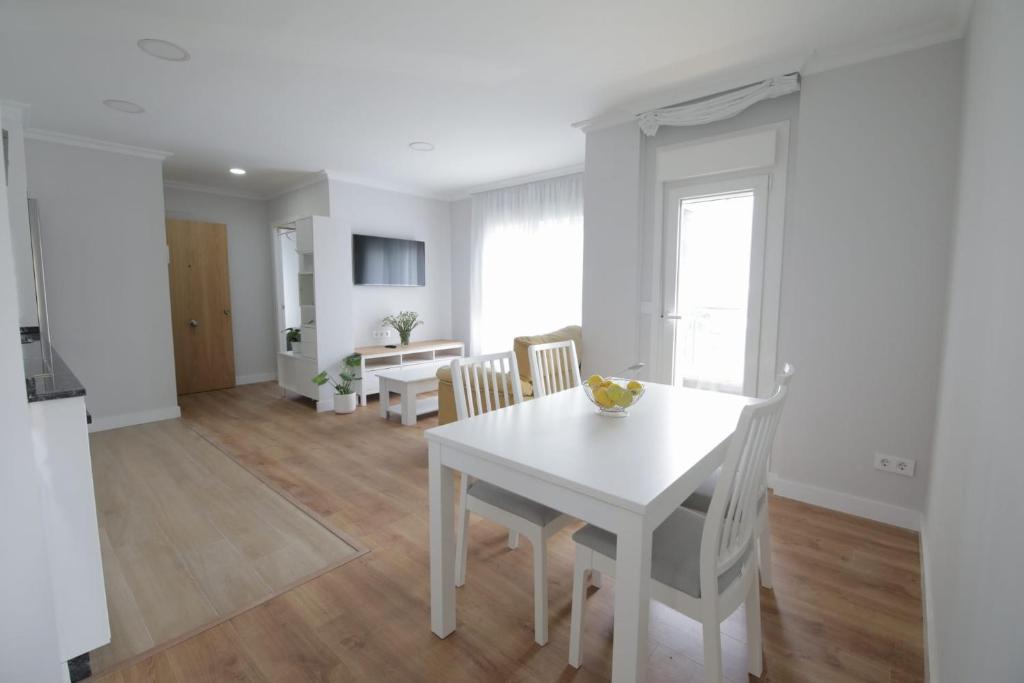 cocina y comedor con mesa blanca y sillas en Encantador apartamento en Marín, en Marín