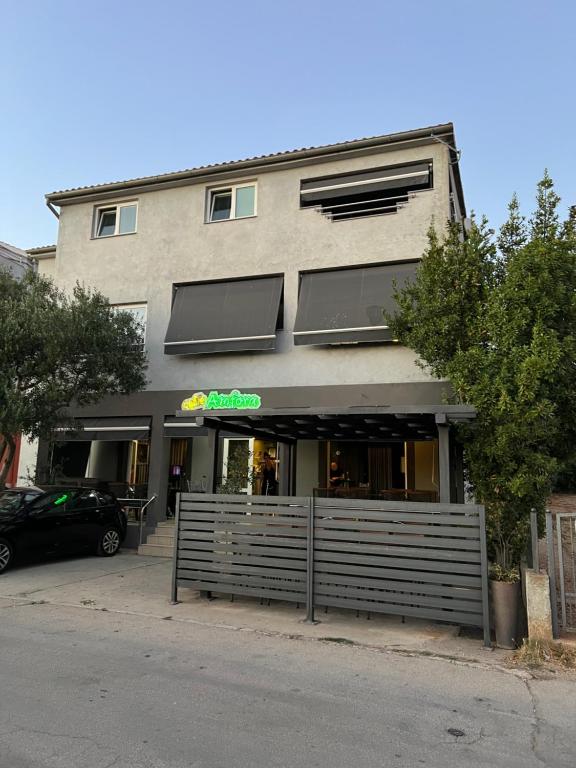 a building with a sign on the front of it at Amfora in Bibinje