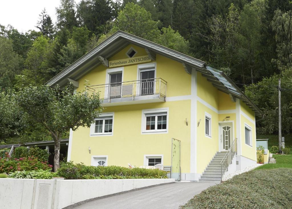 a yellow house with a balcony on the side at Ferienhaus Jantscher in Flattach