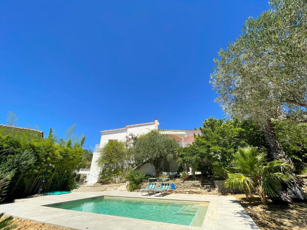 a swimming pool in front of a house at Casita Bouganvilla in Roses