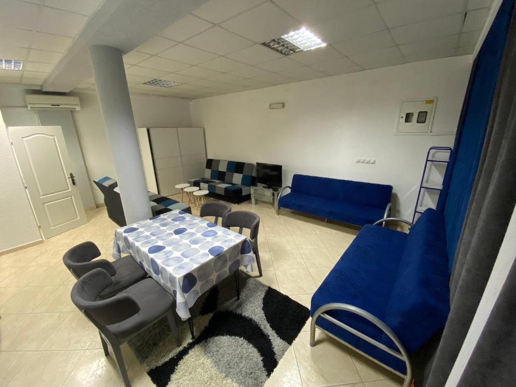 a hospital room with a table and chairs and a couch at Apartman Marija in Ulcinj