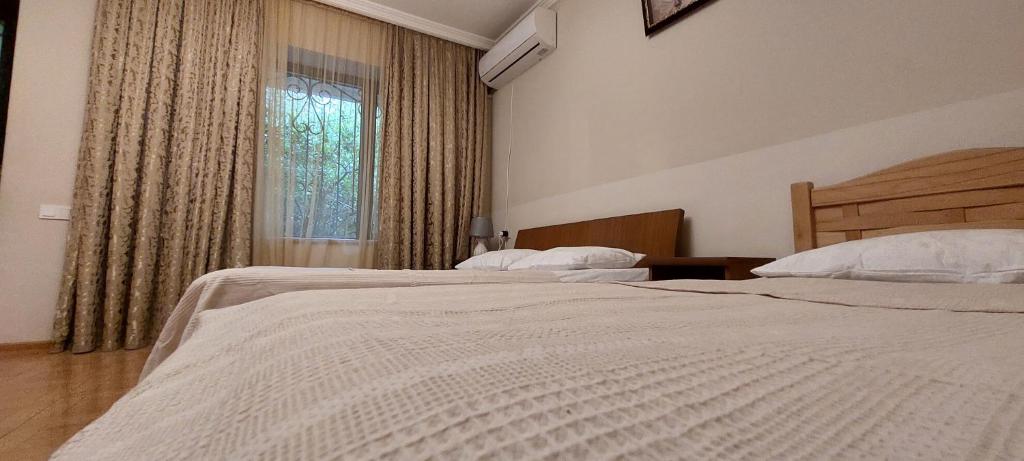 a bedroom with two beds and a window at Geo Kutaisi in Kutaisi