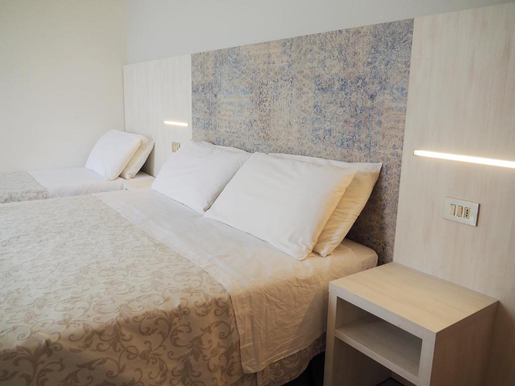 Postel nebo postele na pokoji v ubytování Hotel Olympia