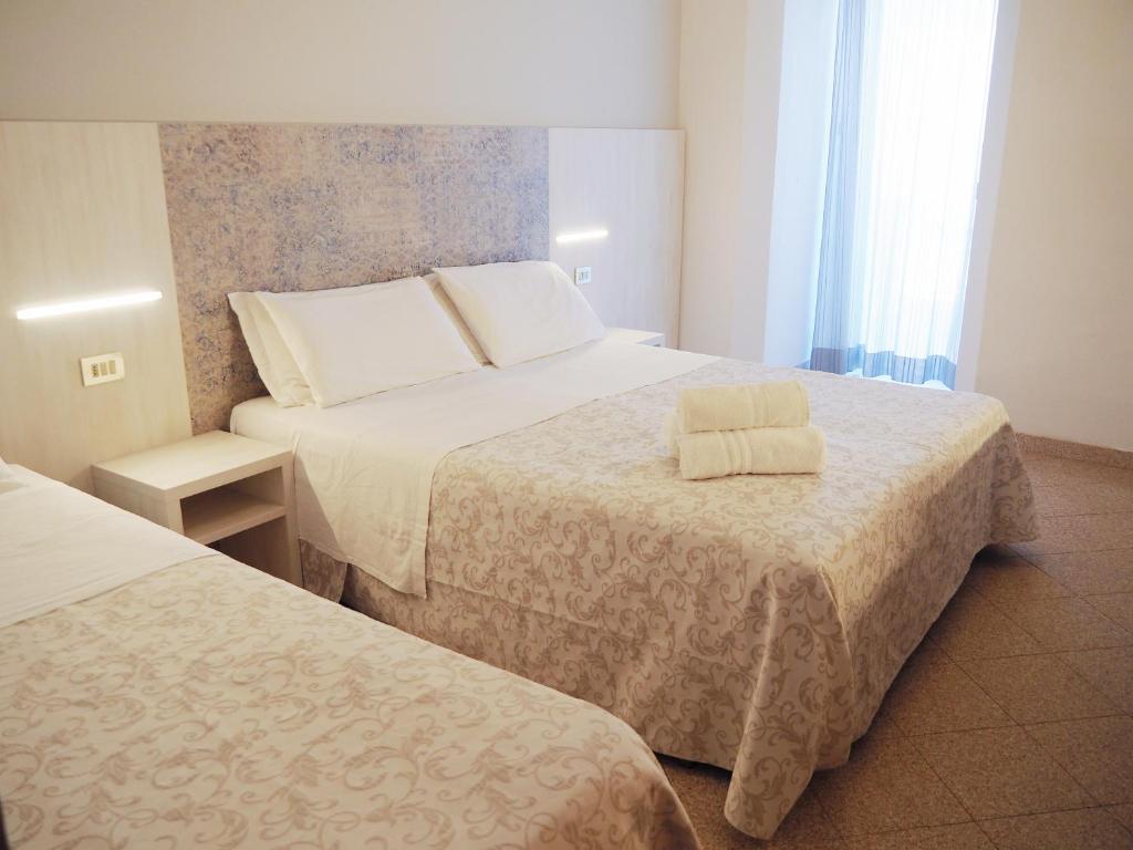 Postel nebo postele na pokoji v ubytování Hotel Olympia