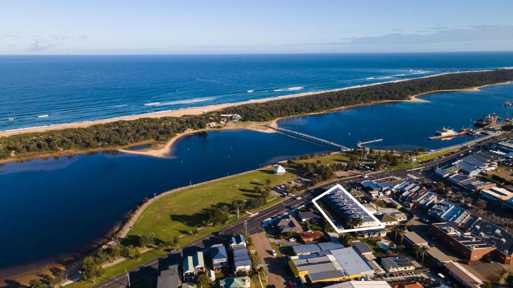 an aerial view of a beach and the ocean at Esplanade Escape in Lakes Entrance