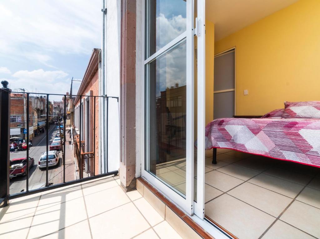 Postel nebo postele na pokoji v ubytování Hotel Zaragoza, San Juan de los Lagos