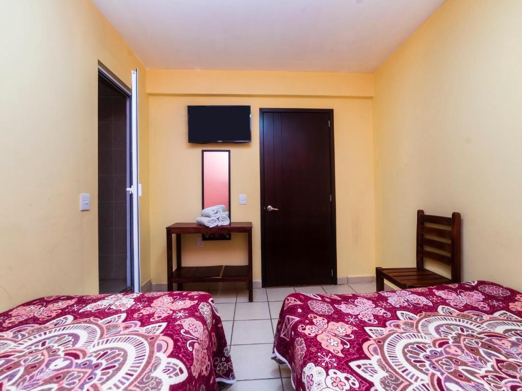 Postel nebo postele na pokoji v ubytování Hotel Zaragoza, San Juan de los Lagos