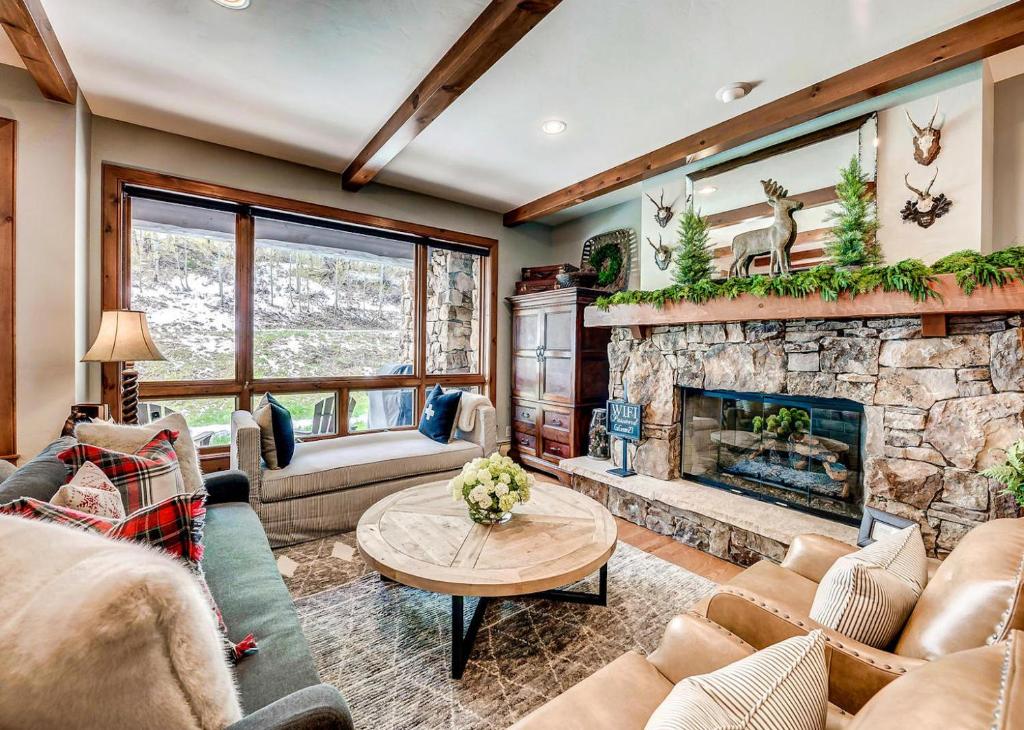 a living room with a stone fireplace at 205 Bear Paw Lodge in Avon