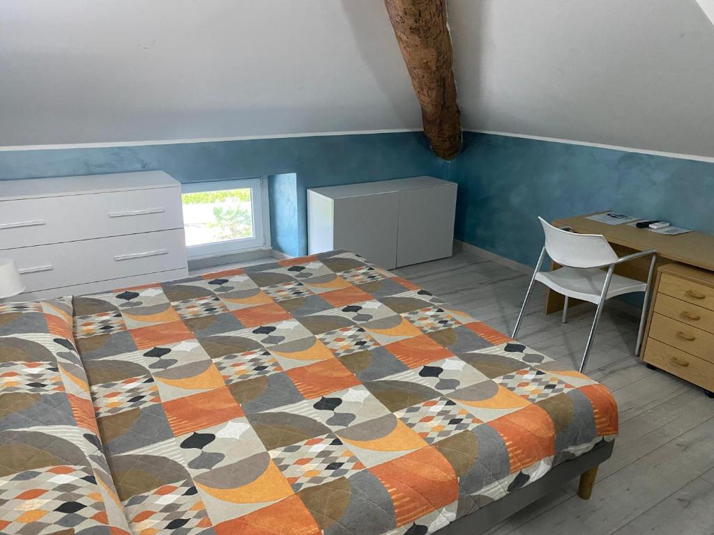 a bedroom with a bed and a desk and a chair at Pluto Centrale in Cadenazzo