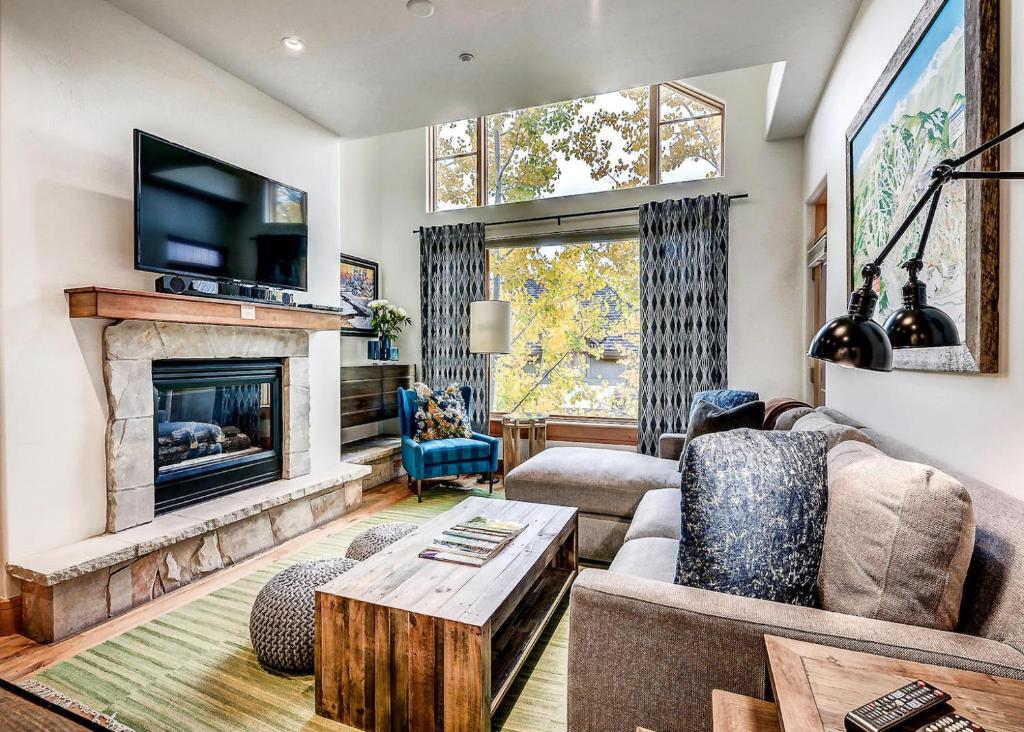 a living room with a couch and a fireplace at 306 Aspenwood Lodge in Edwards