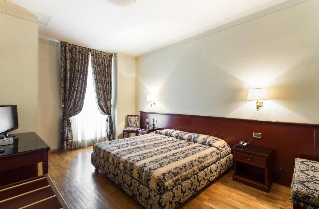 Postel nebo postele na pokoji v ubytování Hotel Gambara