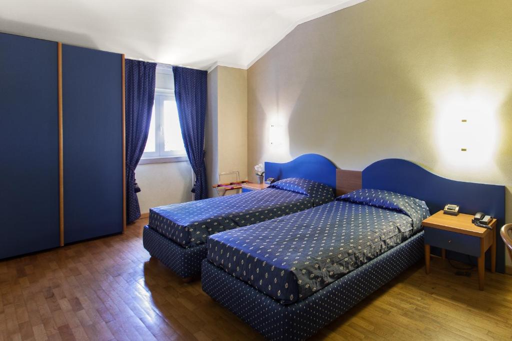 Postel nebo postele na pokoji v ubytování Hotel Gambara