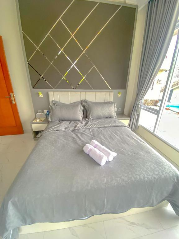 Postel nebo postele na pokoji v ubytování Algara Puncak Hotel