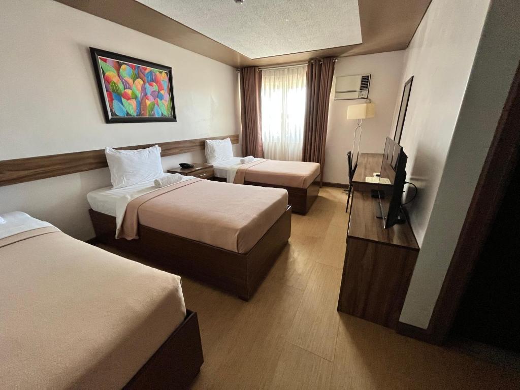 Postel nebo postele na pokoji v ubytování Leope Hotel