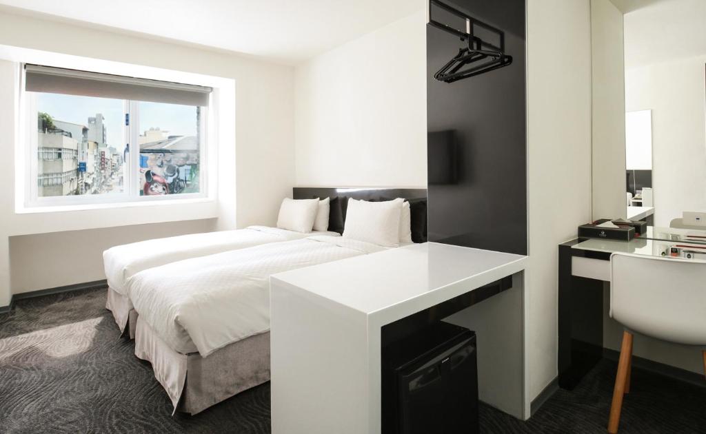 Postel nebo postele na pokoji v ubytování CityInn Hotel Plus - Taichung Station Branch
