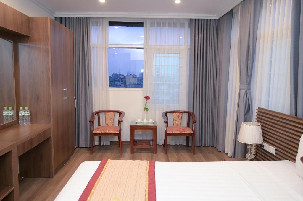 Postel nebo postele na pokoji v ubytování Mercy Hotel