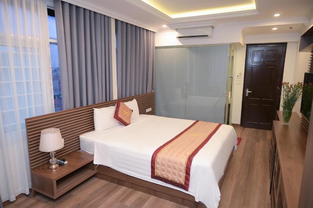 Postel nebo postele na pokoji v ubytování Mercy Hotel