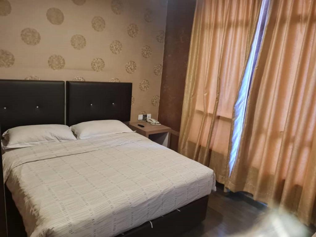 Postel nebo postele na pokoji v ubytování Hotel Nusa CT