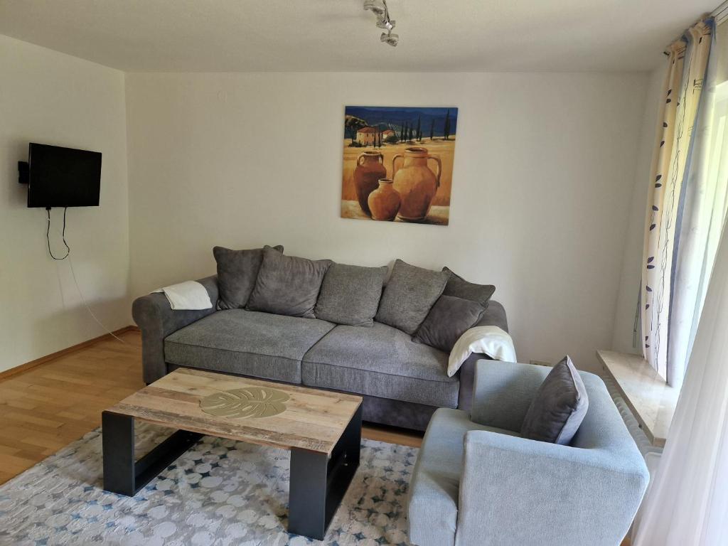 a living room with a couch and a coffee table at Ferienwohnung Leo in Bad Endorf