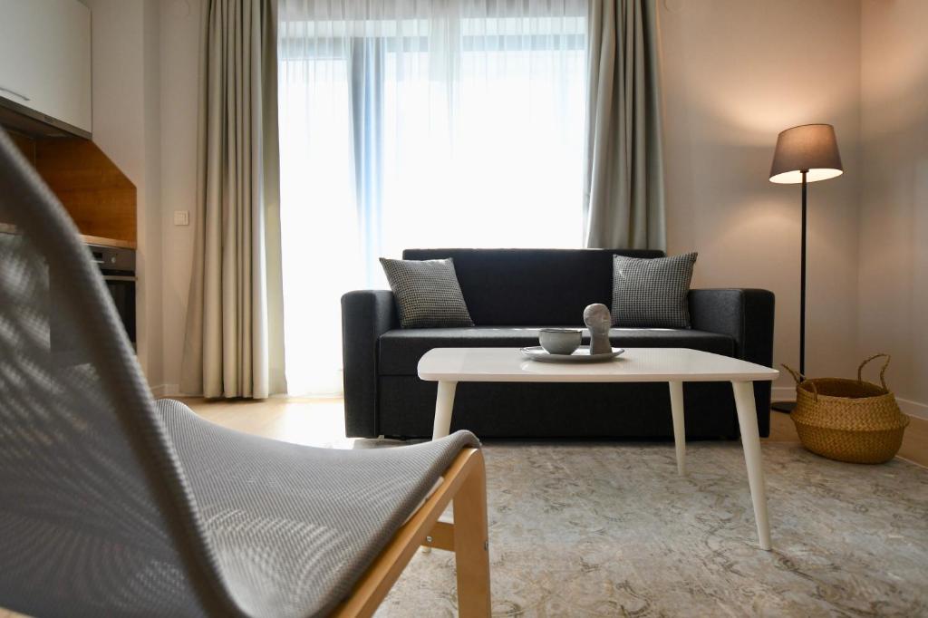 a living room with a couch and a table at Connect Living Apartments Free Parking in Sofia