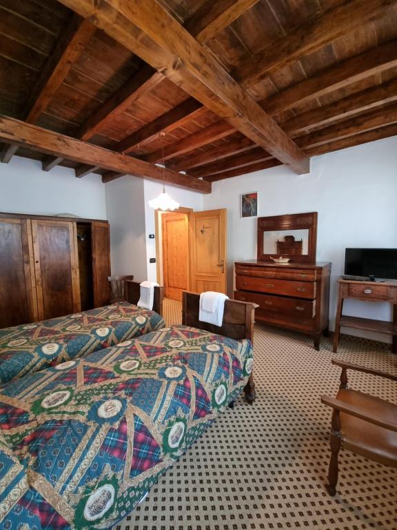 Postel nebo postele na pokoji v ubytování Trattoria Albergo all'Alpino