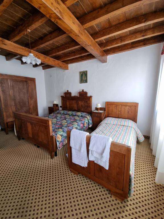 Postel nebo postele na pokoji v ubytování Trattoria Albergo all'Alpino