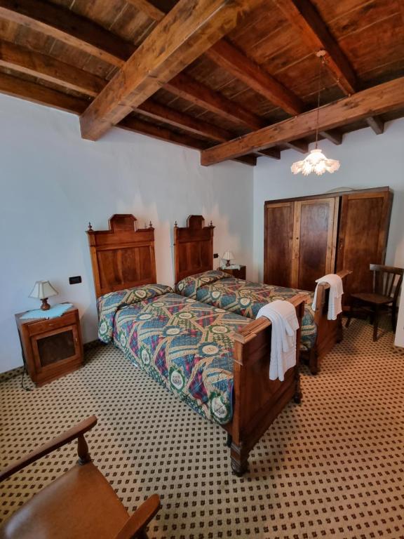 Postel nebo postele na pokoji v ubytování Trattoria Albergo all'Alpino