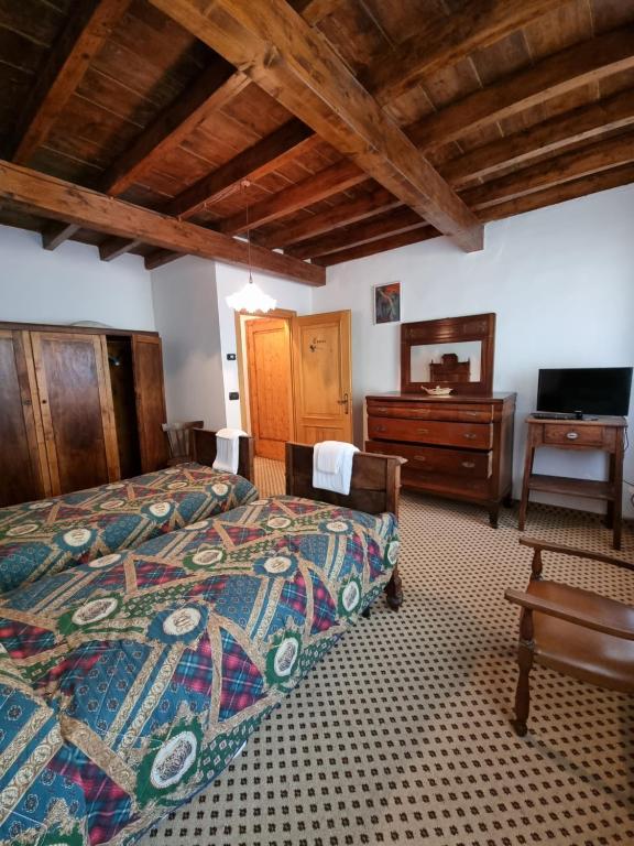 Postel nebo postele na pokoji v ubytování Trattoria Albergo all'Alpino