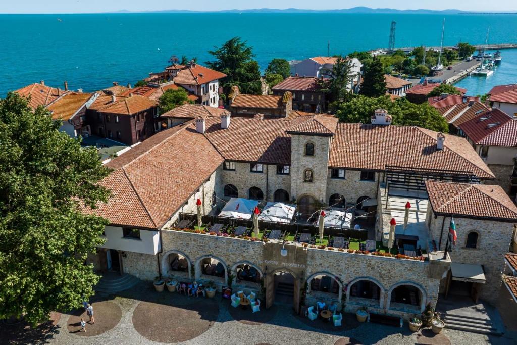 an aerial view of a building in a town next to the ocean at Castro Mesembria Boutique Hotel in Nesebar