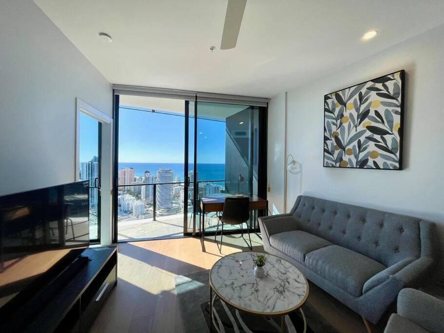 a living room with a couch and a table at Brand new luxury OceanView 2beds apt 40F in Gold Coast