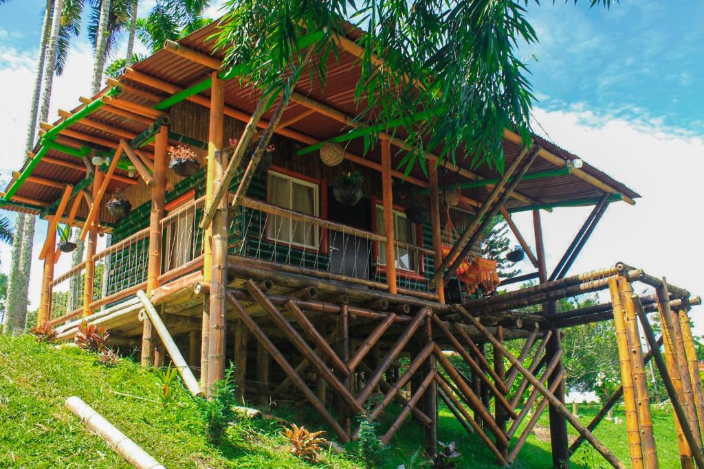 a wooden house on top of a hill at Room in Lodge - Glamping Cabin in Rizaralda