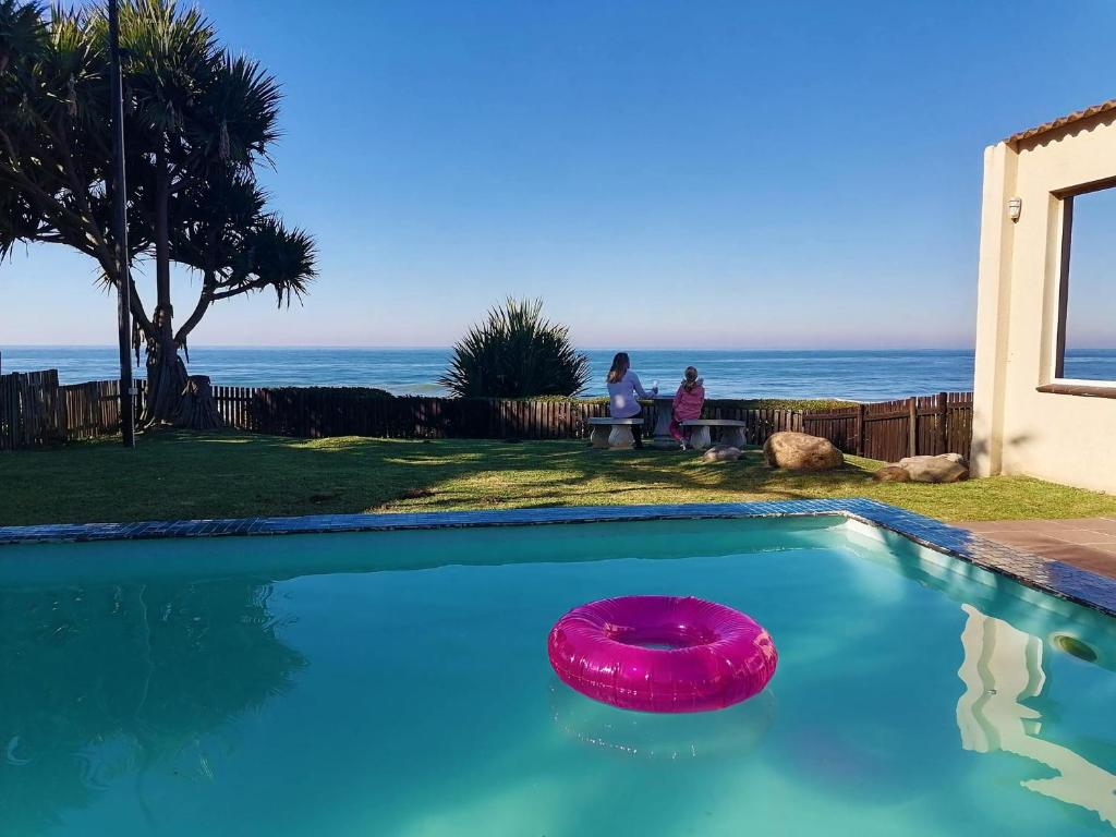 a pink frisbee is sitting in a swimming pool at Southern Comfort - On the Pool in Margate