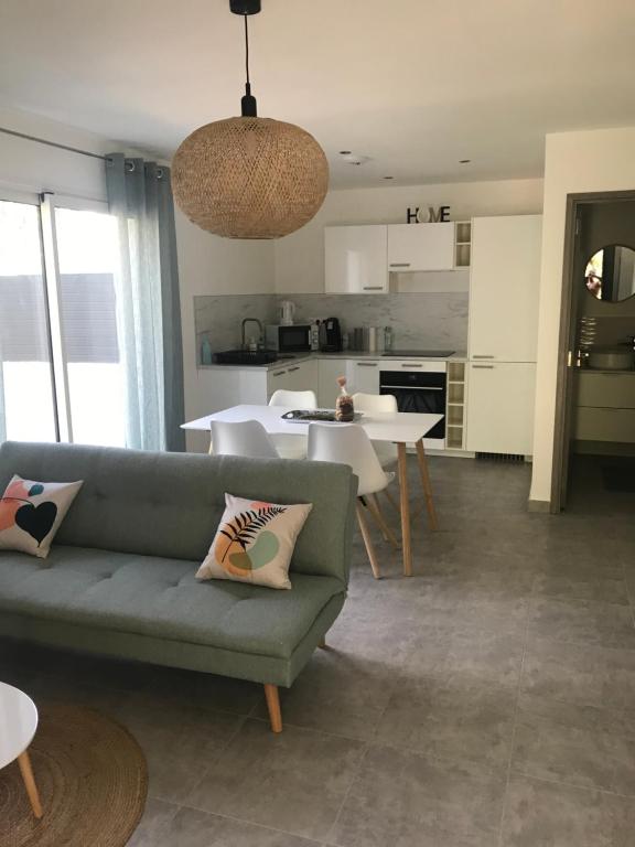 a living room with a couch and a table at Les jardins de Saint Pancrace in Corte