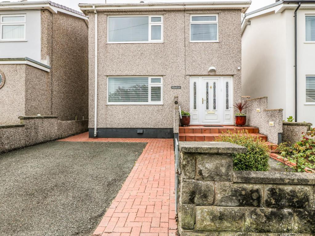 a house with a brick driveway in front of it at Glasfryn in Holyhead