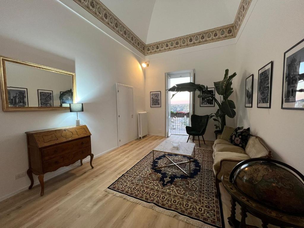 a living room with a couch and a table at Palazzo Zagarella HOWME in Matera