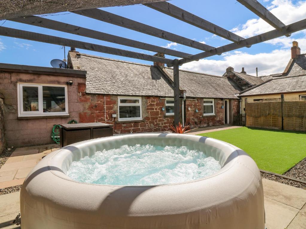 a hot tub in the backyard of a house at 20 Doune Cottage in Brechin