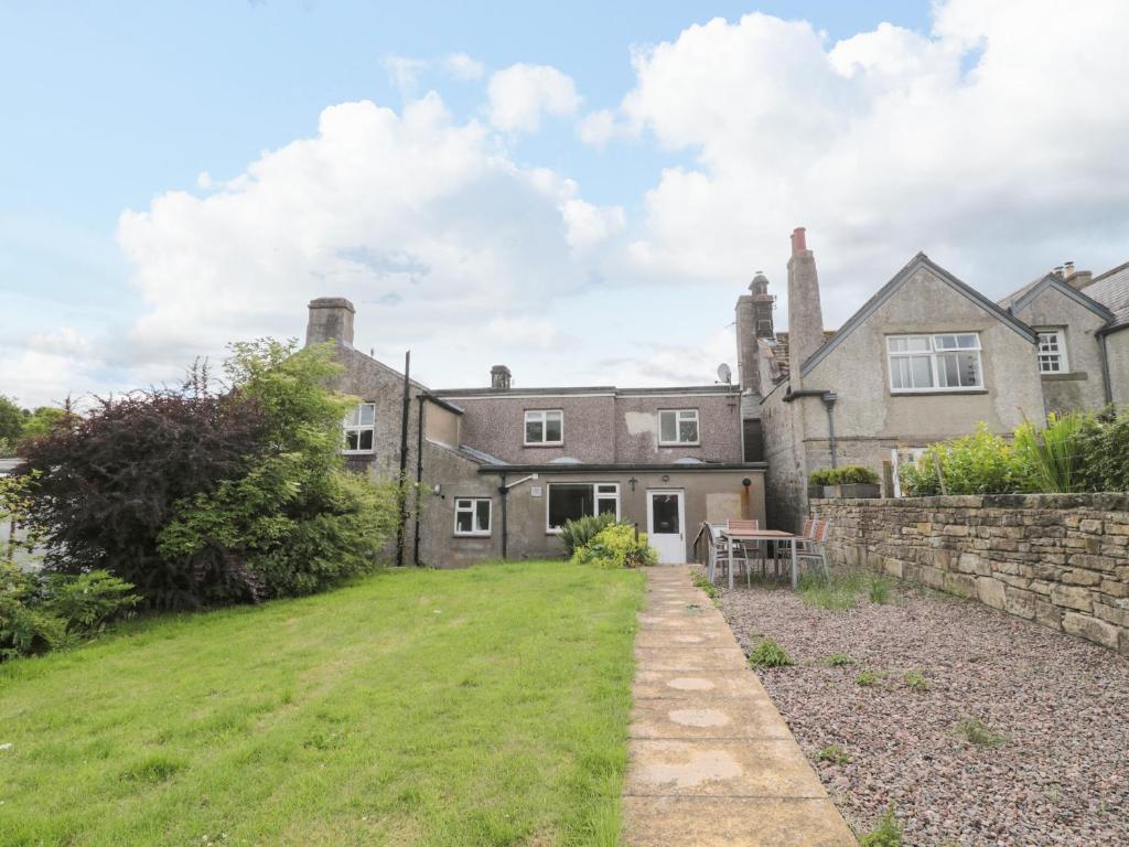 an exterior view of a large house with a yard at Ravens Heugh in Morpeth