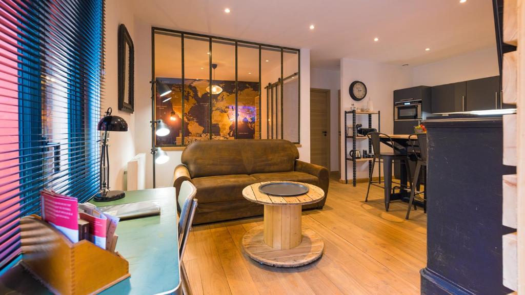 salon z kanapą i stołem w obiekcie L'Atelier Flanelle w mieście Le Mans